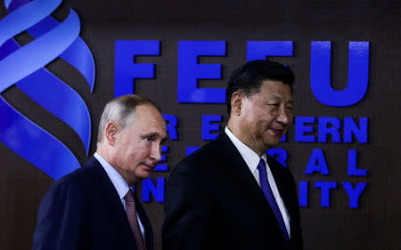 Russian President Vladimir Putin and Chinese President Xi Jinping attend a meeting with participants of a round table discussion on Russia-China Cooperation on the sidelines of the Eastern Economic Forum in Vladivostok, Russia September 11, 2018. Vladimir Smirnov/TASS Host Photo Agency/Pool via REUTERS