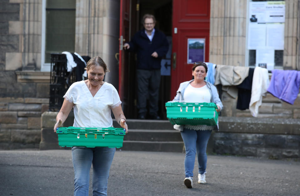 Volunteers from the Step to Hope charity carry meals to give to those who want one in the grounds of The Parish Church of St Cuthbert in Edinburgh. The charity in Edinburgh which is handing out meals to the homeless, normally meals are served inside the church, however due to restrictions these are being handed outside to the homeless as the UK continues in lockdown to help curb the spread of the coronavirus.