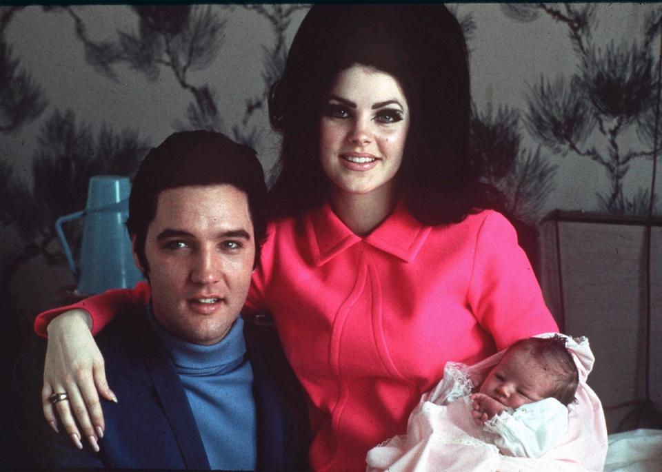 Elvis Presley poses with wife Priscilla and daughter Lisa Marie, in a room at Baptist hospital in Memphis (AP)