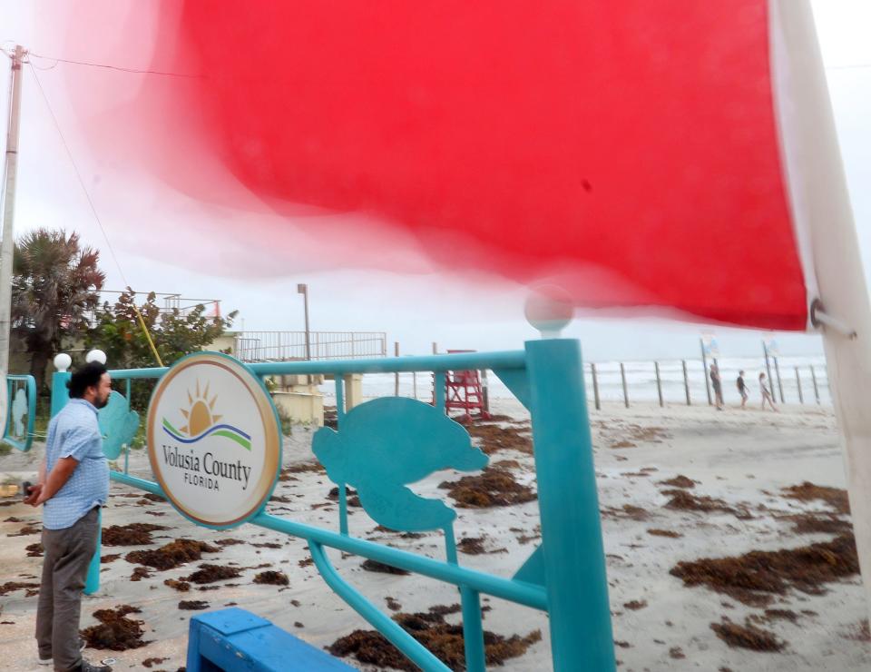 A beach warning flag whips wildly in the wind at the International Speedway Blvd. approach,, Monday November 9, 2020.