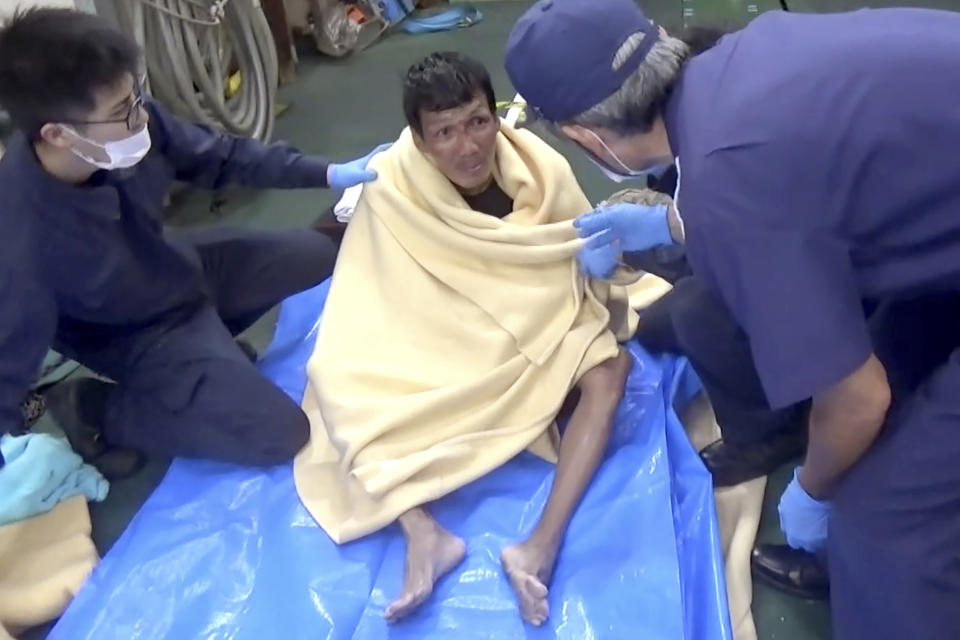 In this image made from video released by the 10th Regional Japan Coast Guard Headquarters, a rescued crew member of a Panamanian cargo ship speaks to Japanese Coast Guard members off the Amami Oshima, Japan Wednesday, Sept. 2, 2020. Japanese rescuers have safely plucked the crew member from the sea while searching for the cargo ship carrying more than 40 crew and thousands of cows went missing after sending a distress call off the southern Japanese island. (The 10th Regional Japan Coast Guard Headquarters via AP)