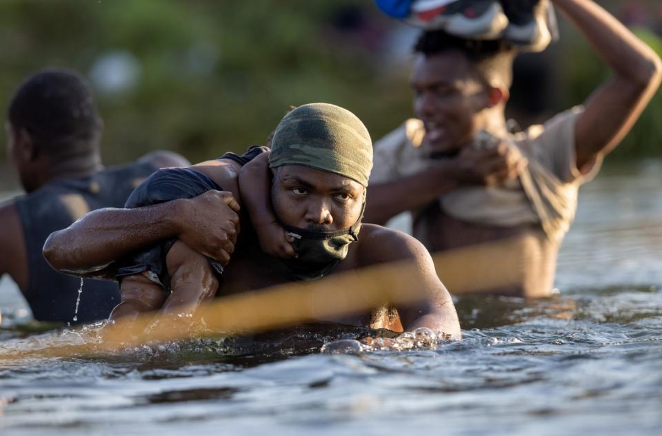 Haitian immigrants cross the Rio Grande back into Mexico from Del Rio, Texas on September 20, 2021 to Ciudad Acuna, Mexico.