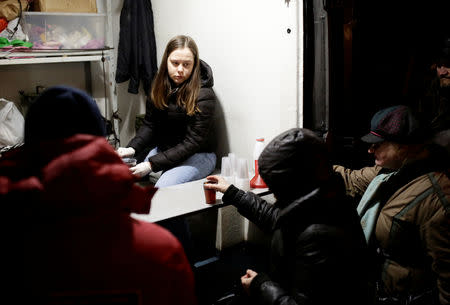 People queue near a van of 'Nochlezhka' charity organization as volunteers distribute meals for the homeless in St. Petersburg, Russia December 5, 2018. REUTERS/Anton Vaganov