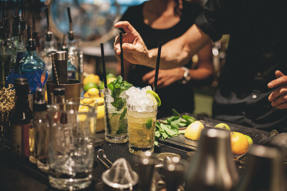 Bartender is preparing mojito cocktails.