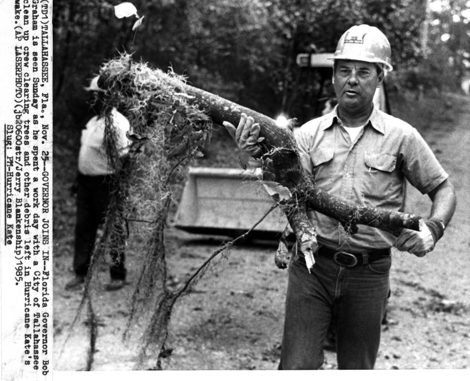 Nov. 25, 1985:  Then-Gov. Bob Graham works for the city of Tallahassee on a crew clearing debris left by Hurricane Kate. (Photo by the Associated Press)  ORG XMIT: COX
