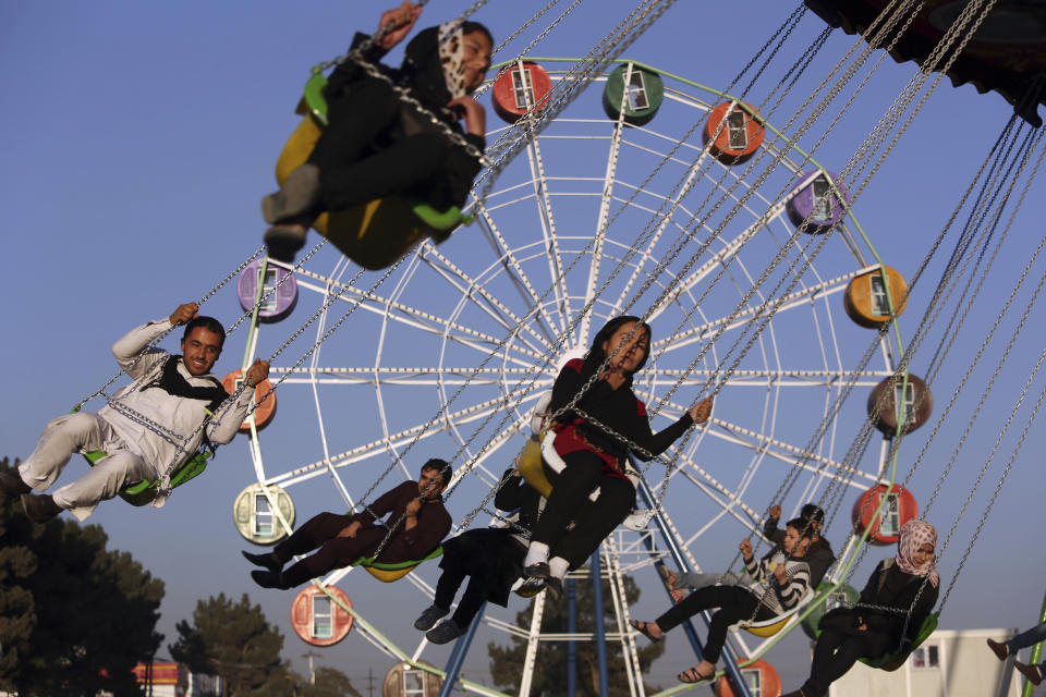 FILE - In this Nov. 14, 2014 file photo, visitors ride a ferris wheel at Afghanistan's first amusement park called City Park, in Kabul. The Taliban fighters who rolled into Afghanistan's capital and other cities in recent days appear awestruck by the towering apartment blocks, modern office buildings and shopping malls. When the Taliban last seized power, in 1996, the country had been ravaged by civil war and the capital was in ruins. (AP Photo/Rahmat Gul, File)