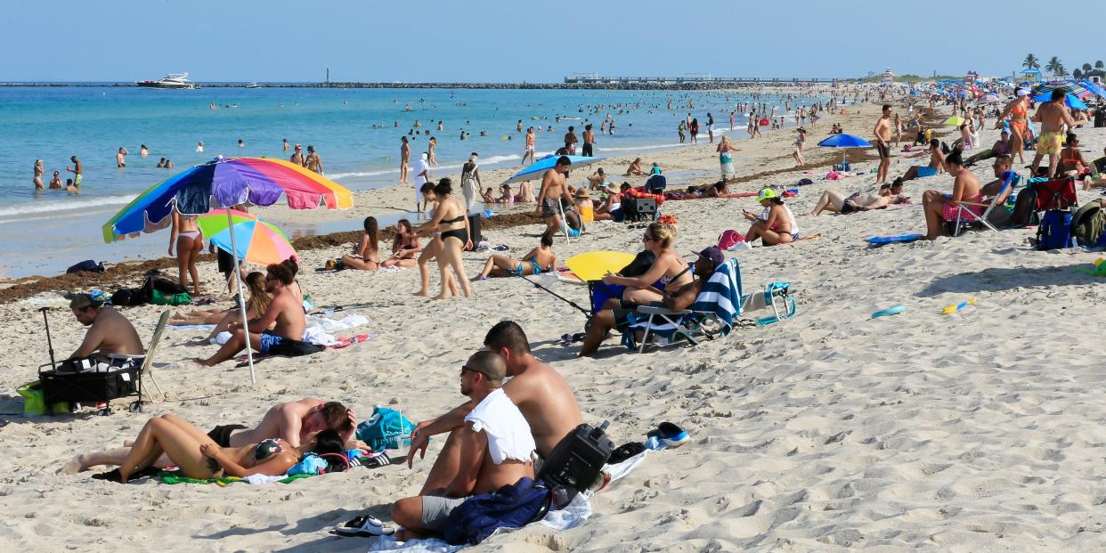 Beachgoers take advantage of the opening of South Beach on June 10, 2020, in Miami Beach, Florida.