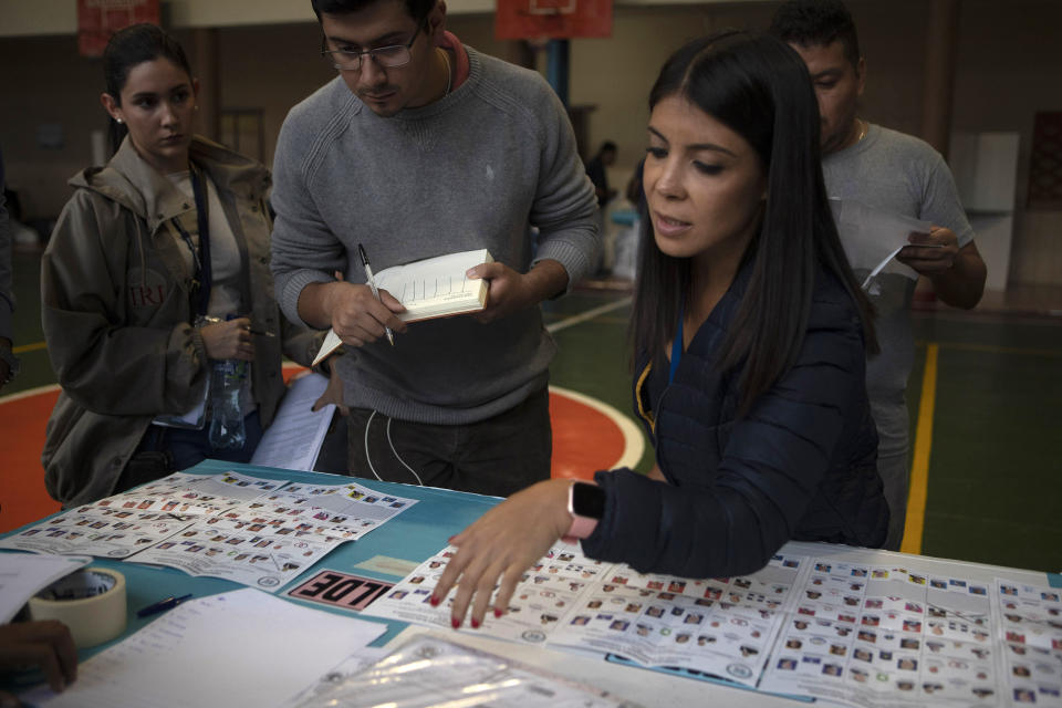 Election officials start counting votes after polls closed during general elections in Guatemala City, Sunday, June 16, 2019. Guatemalans are voting for their next president in elections plagued by widespread disillusion and distrust, and as thousands of their compatriots flee poverty and gang violence to seek a new life in the United States. (AP Photo/Moises Castillo)