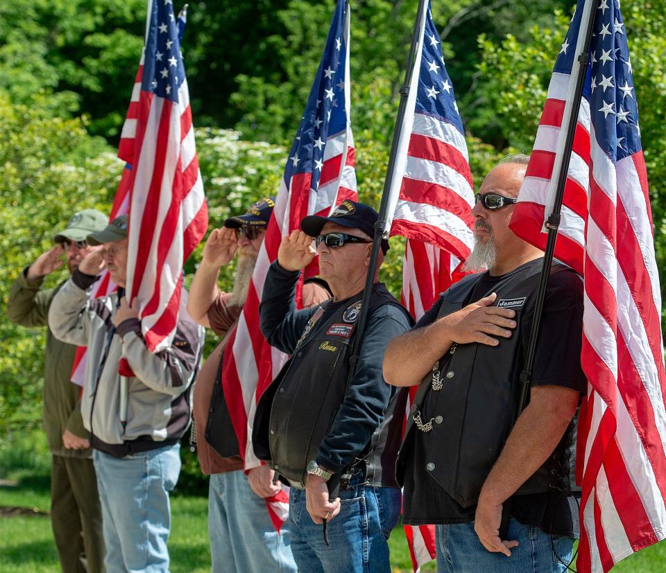 Members of the Warrior Watch salute as the casket carrying the remains of WW II U.S. Army Pvt. Walter G. Wildman, of Bristol, is brought to Shelter 1 for reinterment, Monday, May 23, 2022, at Washington Crossing National Cemetery.