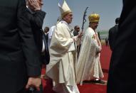 Pope Francis strides towards the stage to lead mass on April 29, 2017 at a stadium in Cairo