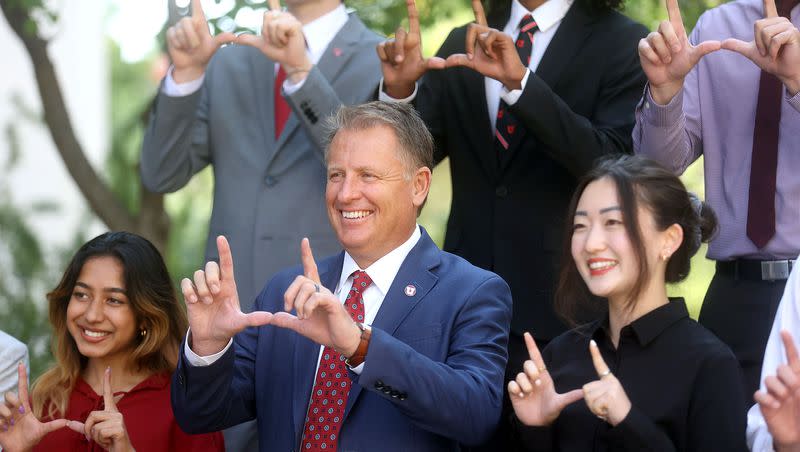 University of Utah President Taylor Randall, center, makes a “U” sign while posing for a photo with presidential interns at the University of Utah in Salt Lake City on Aug. 20, 2021. Sanila Math is on the left and Jaina Lee is on the right.