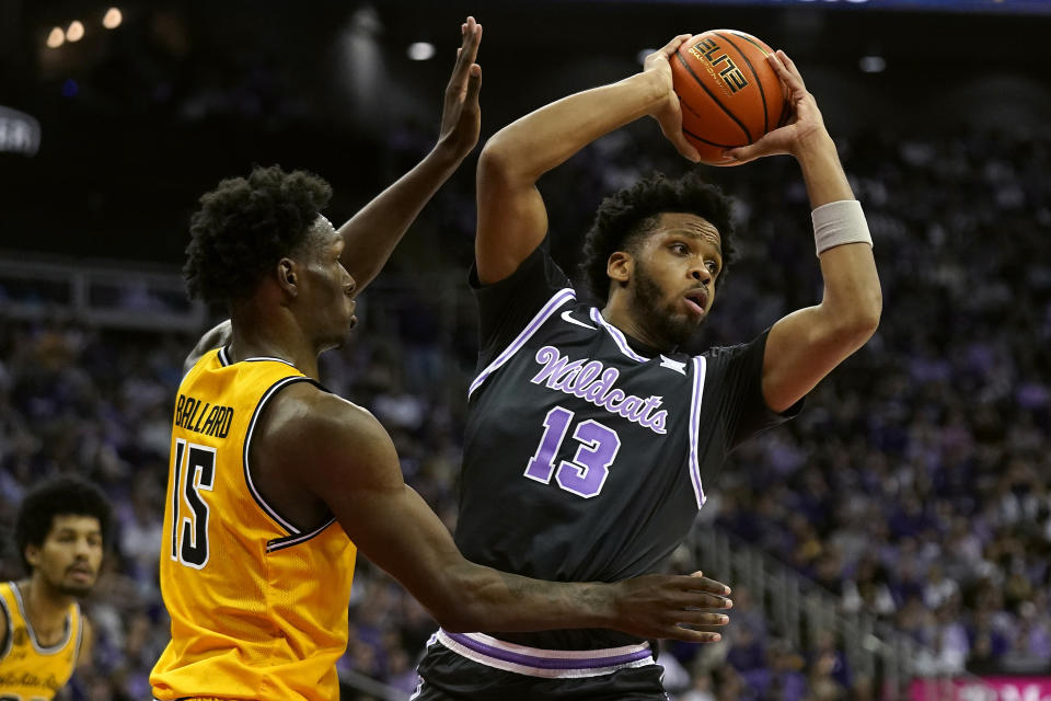 Kansas State forward Will McNair Jr. (13) looks to pass under pressure from Wichita State center Quincy Ballard (15) during the first half of an NCAA college basketball game Thursday, Dec. 21, 2023, in Kansas City, Mo. (AP Photo/Charlie Riedel)