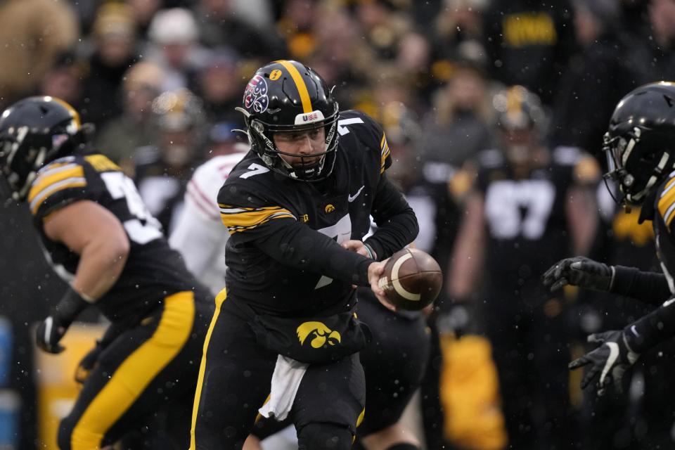 Iowa quarterback Spencer Petras hands the ball off against Wisconsin, Saturday, Nov. 12, 2022, in Iowa City, Iowa. The Aggies snatched the former Hawkeye from the transfer portal. | Charlie Neibergall, Associated Press