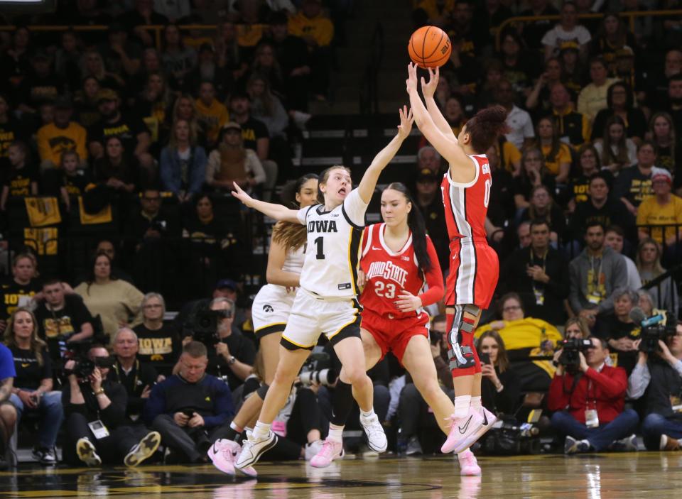 Iowa's Molly Davis defends a shot by Ohio State's Madison Greene on Sunday.