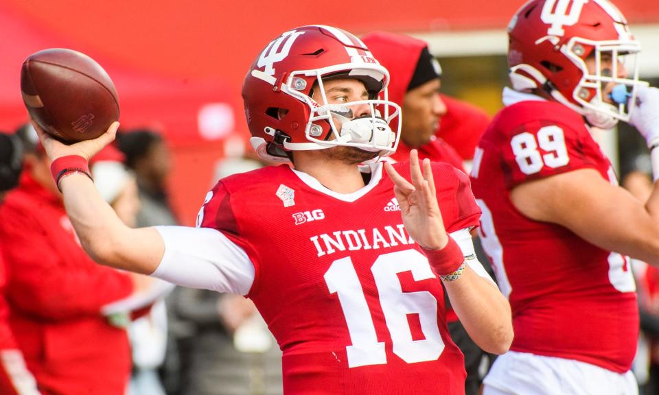 Indiana's Grant Gremel (16) throws during warm-ups before the start of the Indiana versus Minnesota football game at Memorial Stadium on Saturday, Nov. 20, 2021.