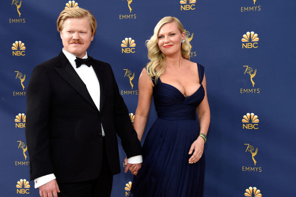 The real life couple holding hands as the walk the red carpet of the Emmys