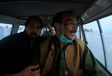 An injured supporter of Pakistani opposition leader Imran Khan sits in an ambulance after clashes between police and protesters in Swabi, between Peshawar and Islamabad, Pakistan October 31, 2016. REUTERS/Fayaz Aziz