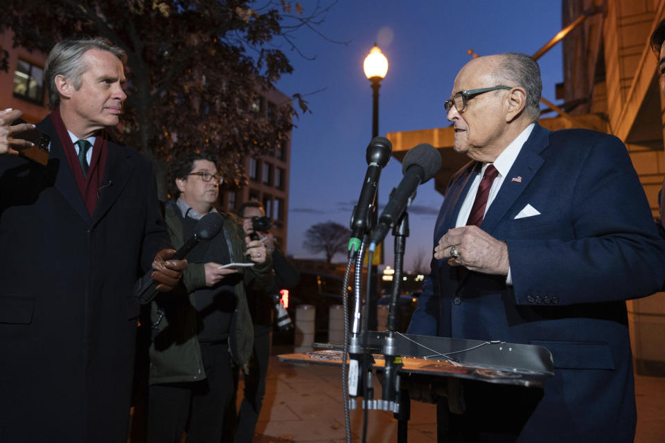 Former New York Mayor Rudy Giuliani talks to reporters as he leaves the federal courthouse in Washington, Monday, Dec. 11, 2023. The trial will determine how much Giuliani will have to pay two Georgia election workers who he falsely accused of fraud while pushing President Donald Trump's baseless claims after he lost the 2020 election. (AP Photo/Jose Luis Magana)