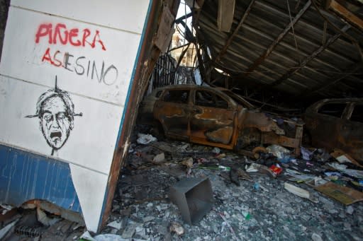 Some areas of Valparaiso have been reduced to rubble -- here, a sign reads "Pinera assassin," referring to Chile's President Sebastian Pinera