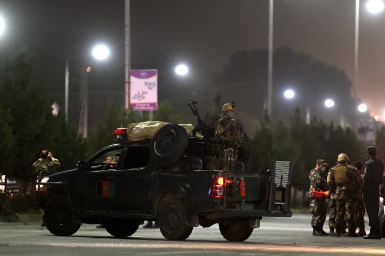 Afghan security forces stand guard near the site of a suicide attack at the entrance to the Police Academy in Kabul on August 7, 2015