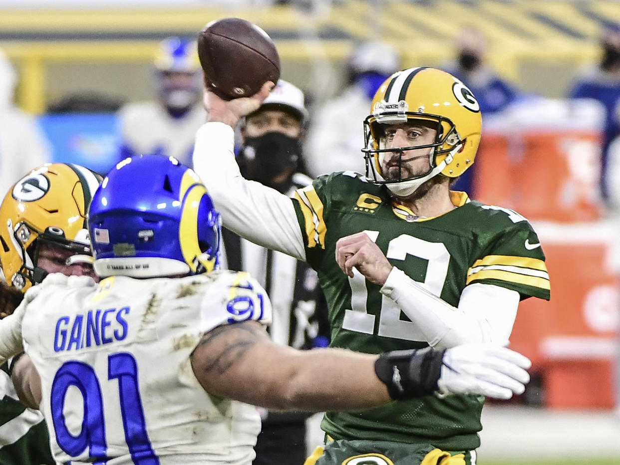 Jan 16, 2021; Green Bay, Wisconsin, USA; Green Bay Packers quarterback Aaron Rodgers throws a pass in the first quarter during the game against the Los Angeles Rams at Lambeau Field. Mandatory Credit: Benny Sieu-USA TODAY Sports