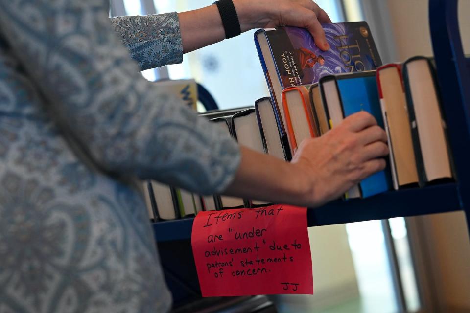 St. Tammany Parish Library Director Kelly LaRocca shows off a cart of books that were removed from the shelves at the Peter L. ‘Pete’ Gitz Library on Feb. 13, 2023, in Madisonville, La. <a href="https://www.gettyimages.com/detail/news-photo/st-tammany-parish-library-director-kelly-larocca-shows-off-news-photo/1247658403?adppopup=true" rel="nofollow noopener" target="_blank" data-ylk="slk:Joshua Lott/The Washington Post via Getty Images;elm:context_link;itc:0;sec:content-canvas" class="link ">Joshua Lott/The Washington Post via Getty Images</a>