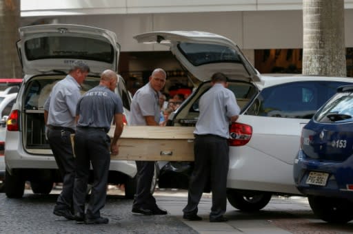 Municipal workers remove bodies from the cathedral. Brazil is one of the most violent countries in the world