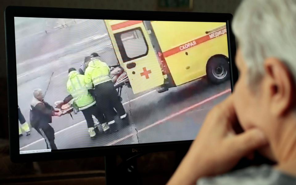 Russian opposition activist and anti-corruption fund head Alexei Navalny is carried on a stretcher by an ambulance team - Shutterstock