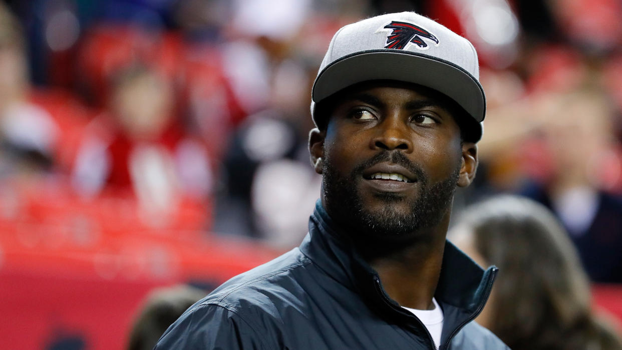 ATLANTA, GA - JANUARY 01: Former Atlanta Falcons player Michael Vick walks on the field prior to the game against the New Orleans Saints at the Georgia Dome on January 1, 2017 in Atlanta, Georgia.