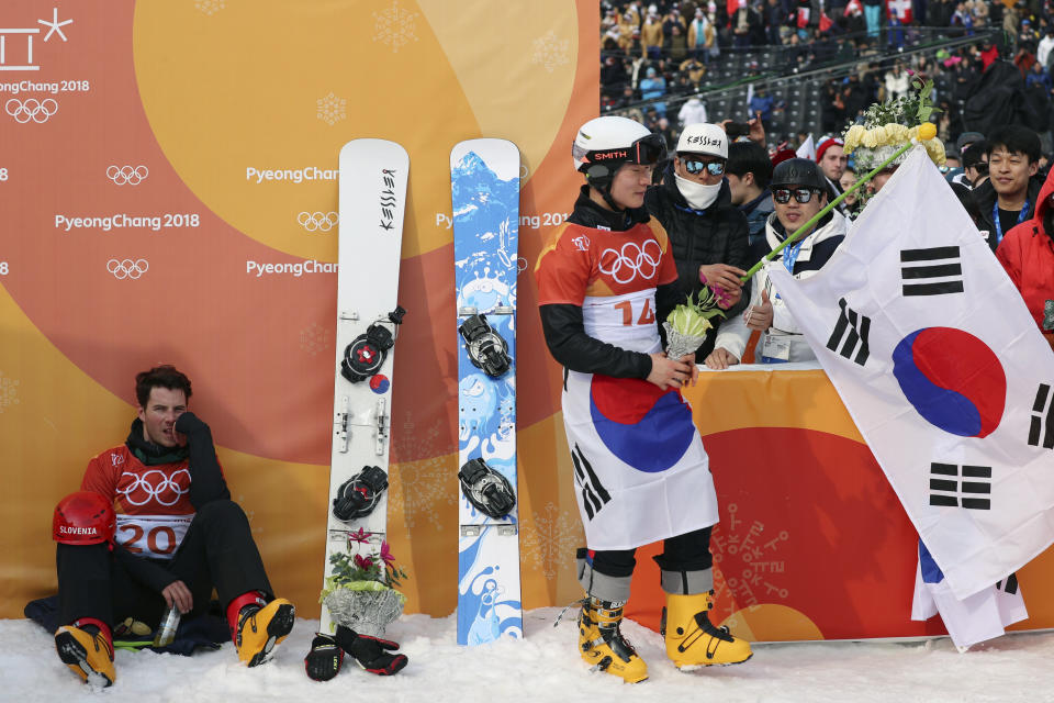 <p>Third placed Zan Kosir of Slovenia sits while second placed Lee Sang-ho of South Korea is congratulated by supporters. REUTERS/Mike Blake </p>