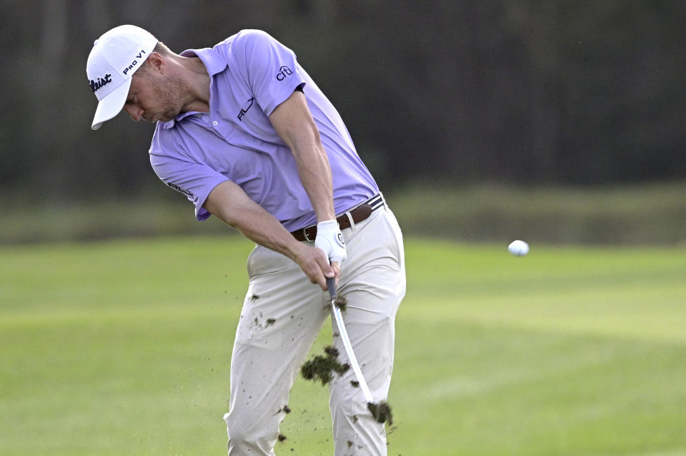 Justin Thomas hits from the 14th fairway during the first round of the PNC Championship golf tournament, Saturday, Dec. 19, 2020, in Orlando, Fla. (AP Photo/Phelan M. Ebenhack)