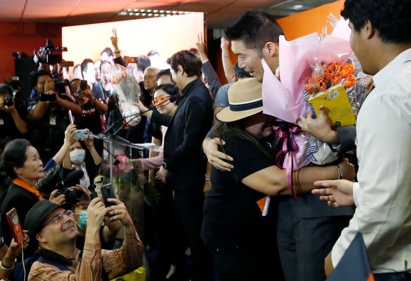 A supporter hugs Future Forward Party leader Thanathorn Juangroongruangkit as he arrives to give a speech, at the party's headquarters in Bangkok