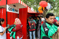 Gojek drivers jostle as they buy food near a Go Pay counter during Go-Food festival in Jakarta, Indonesia, October 27, 2018. Picture taken October 27, 2018. REUTERS/Beawiharta