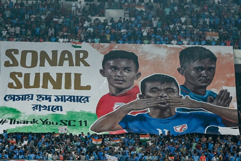 Fans in Kolkata hold a banner displaying photos of India's Sunil Chhetri (DIBYANGSHU SARKAR)