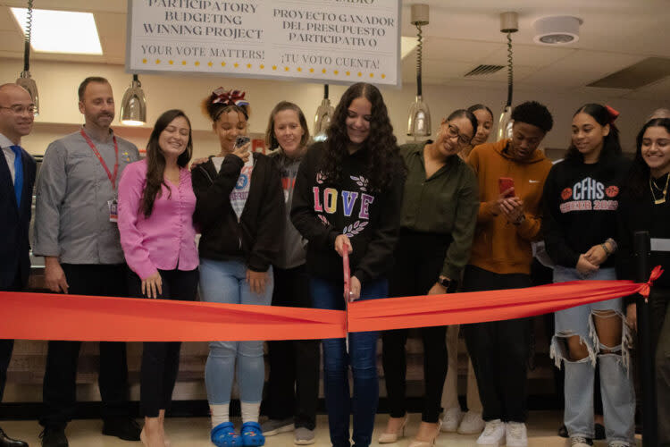 Students in the participatory budgeting elective cut the ribbon on their new cafeteria. Johnson stands second from right. (Courtesy of Pam Jennings)