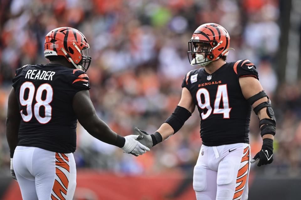 Cincinnati Bengals defensive tackle DJ Reader high fives defensive end Sam Hubbard.