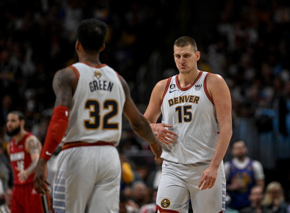 Nikola Jokic (15) and Jeff Green (32) of the Denver Nuggets take a moment after a play in the first quarter during Game 5 of the NBA Finals at Ball Arena in Denver on Monday, June 12, 2023. / Credit: AAron Ontiveroz