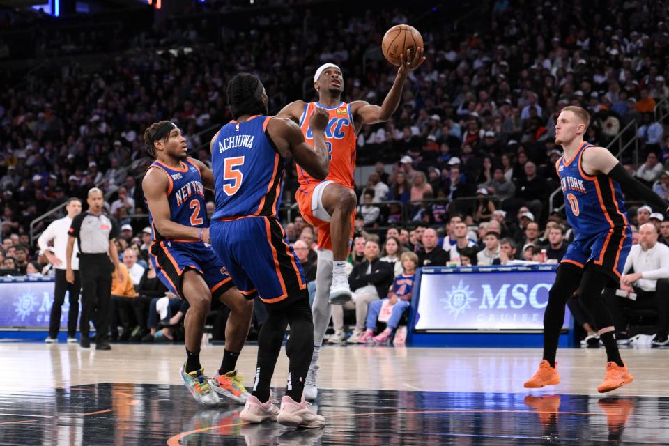 Mar 31, 2024; New York, New York, USA; Oklahoma City Thunder guard Shai Gilgeous-Alexander (2) drives to the basket while being defended by New York Knicks guard Miles McBride (2) and New York Knicks forward Precious Achiuwa (5) during the third quarter at Madison Square Garden. Mandatory Credit: John Jones-USA TODAY Sports