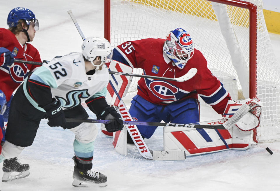 Montreal Canadiens goaltender Sam Montembeault makes a save against Seattle Kraken's Tye Kartye (52) during the first period of an NHL hockey game in Montreal, Monday, Dec. 4, 2023. (Graham Hughes/The Canadian Press via AP)