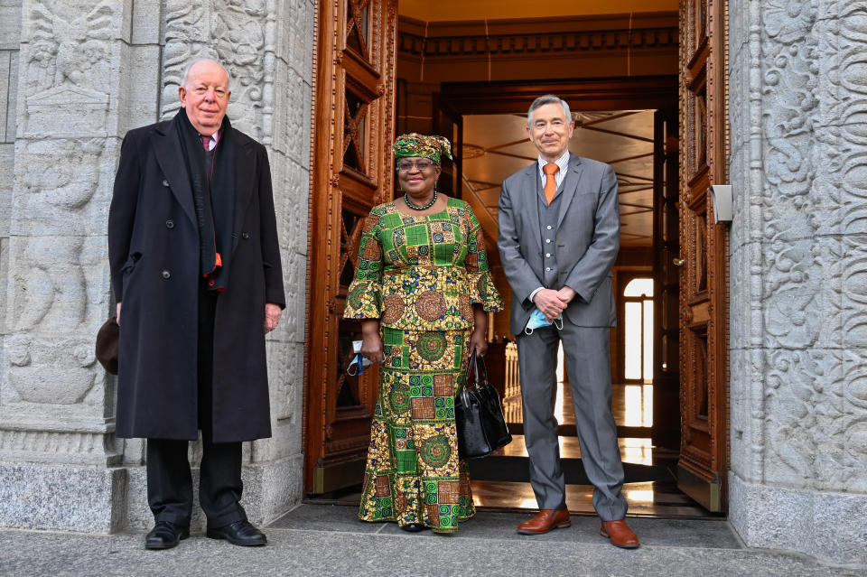 New Director-General of the World Trade Organisation Ngozi Okonjo-Iweala, center, poses between WTO Deputy Directors-General Alan Wolff, left, and Karl Brauner upon her arrival at the WTO headquarters to takes office in Geneva, Switzerland, Monday, March 1, 2021. Nigeria's Ngozi Okonjo-Iweala takes the reins of the WTO amid hope she will infuse the beleaguered body with fresh momentum to address towering challenges and a pandemic-fuelled global economic crisis. (Fabrice Coffrini/Pool/Keystone via AP)