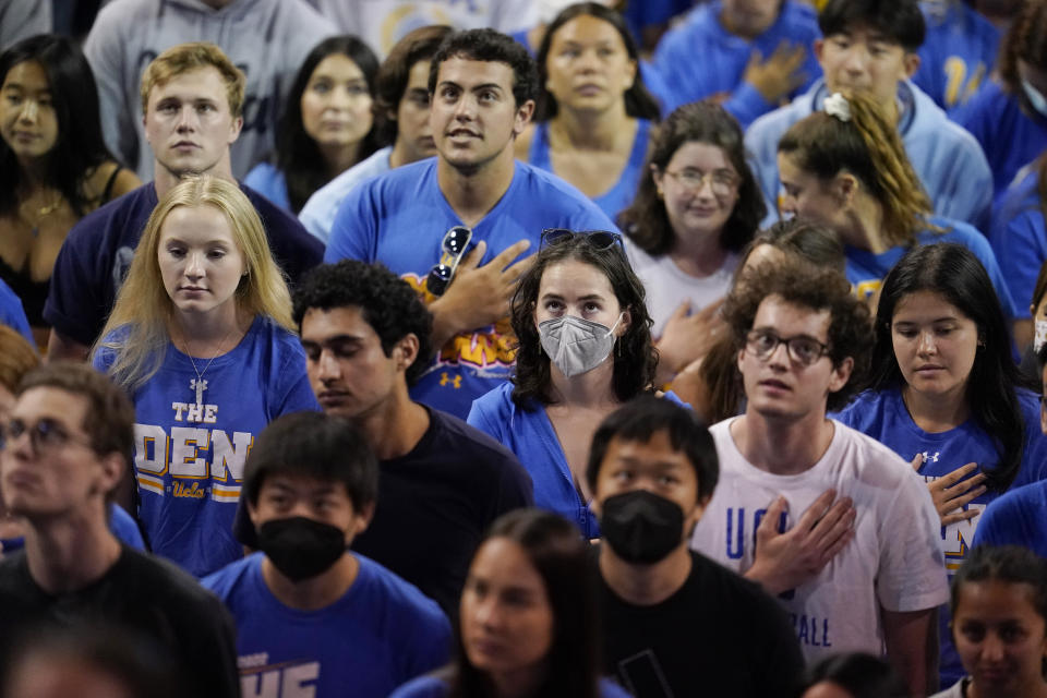 FILE - Students listen to the national anthem before a semifinal between Long Beach State and UCLA in the NCAA men's college volleyball tournament Thursday, May 5, 2022, in Los Angeles. After statewide bans on affirmative action in states from California to Florida, colleges have tried a range of strategies to achieve a diverse student body – giving greater preference to low-income families and admitting top students from communities across their states. But after years of experimentation, some states requiring race-neutral policies have seen drops in Black and Hispanic enrollments. (AP Photo/Marcio Jose Sanchez, File)