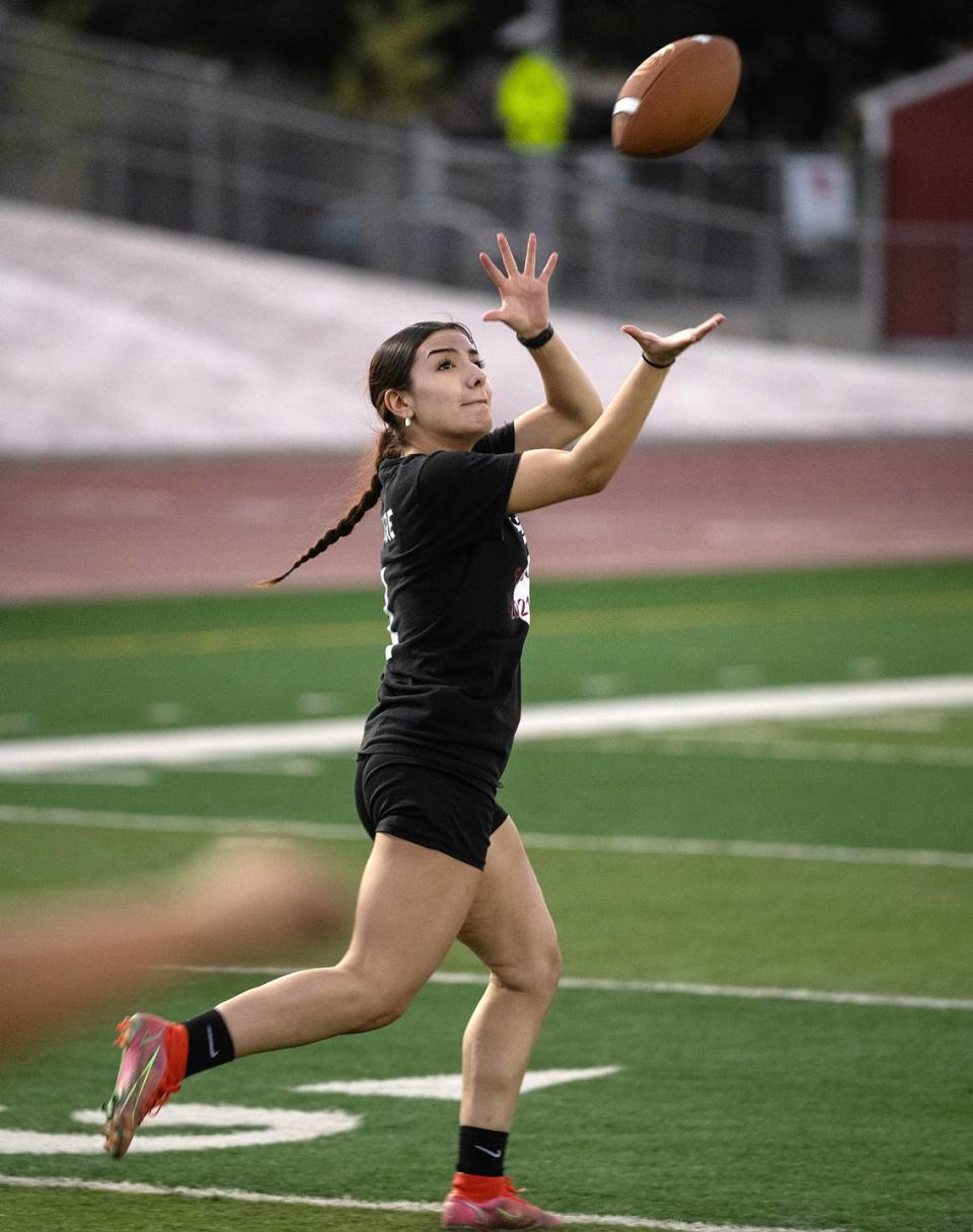 Daisy De La Torre runs a passing route during flag football practice at Patterson High School in Patterson, Calif., Tuesday, August 1, 2023.