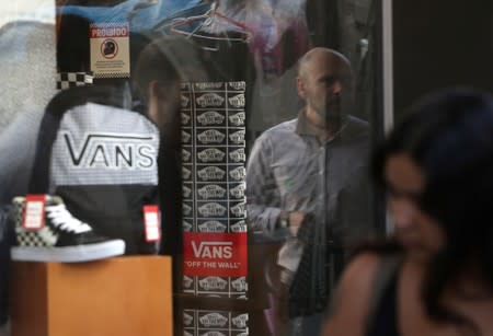 Shoes and backpack of Vans are seen in a shop window in Sao Paulo