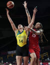 Australia's Marianna Tolo (14) drives to the basket against United States's Brittney Griner (15) during a women's basketball quarterfinal game at the 2020 Summer Olympics, Wednesday, Aug. 4, 2021, in Saitama, Japan. (AP Photo/Eric Gay)