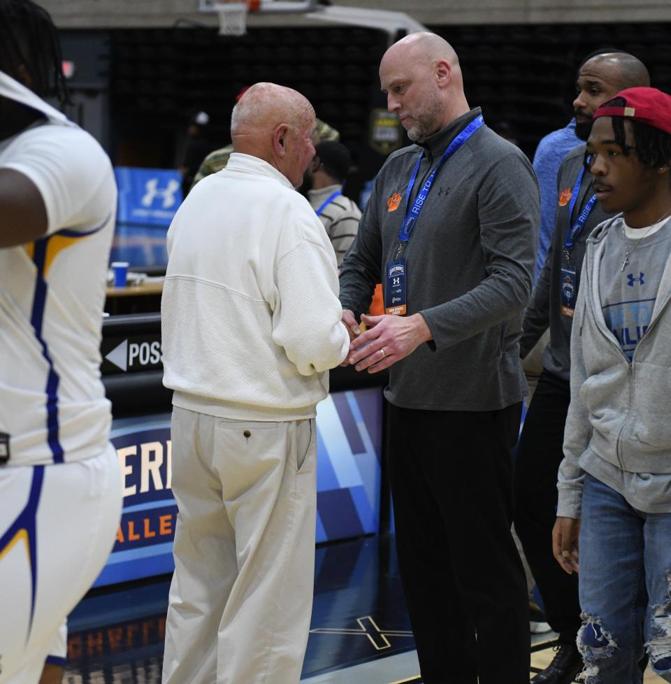 WiHi head coach Butch Waller and Elkins head coach Amrit Rayfield shake hands after WiHi's 71-61 win in Game 2 of the Governor's Challenge.
