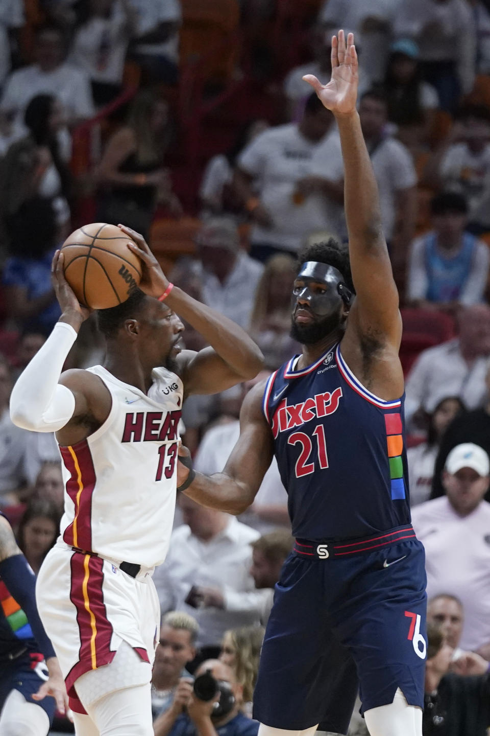 Miami Heat center Bam Adebayo (13) looks for an opening past Philadelphia 76ers center Joel Embiid (21) during the first half of Game 5 of an NBA basketball second-round playoff series, Tuesday, May 10, 2022, in Miami. (AP Photo/Wilfredo Lee)