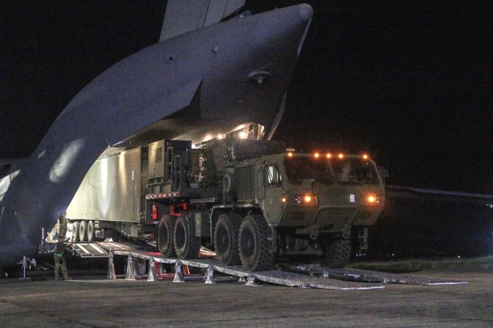 U.S. personnel unload a trailer-based launcher associated with the Typhon weapon system from a C-17A transport aircraft in the Philippines on April 7, 2024. <em>U.S. Army</em>