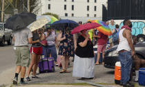 In the aftermath of Hurricane Ida people line up for food and ice at a distribution center Wednesday, Sept. 1, 2021, in New Orleans, La. Louisiana residents still reeling from flooding and damage caused by Hurricane Ida are scrambling for food, gas, water and relief from the oppressive heat. (AP Photo/Eric Gay)