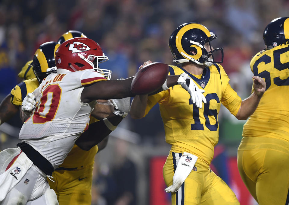 Kansas City Chiefs outside linebacker Justin Houston, left, strips the ball away from Los Angeles Rams quarterback Jared Goff (16) during the second half of an NFL football game, Monday, Nov. 19, 2018, in Los Angeles. Chiefs defensive end Allen Bailey recovered the ball and scored a touchdown. (AP Photo/Kelvin Kuo)