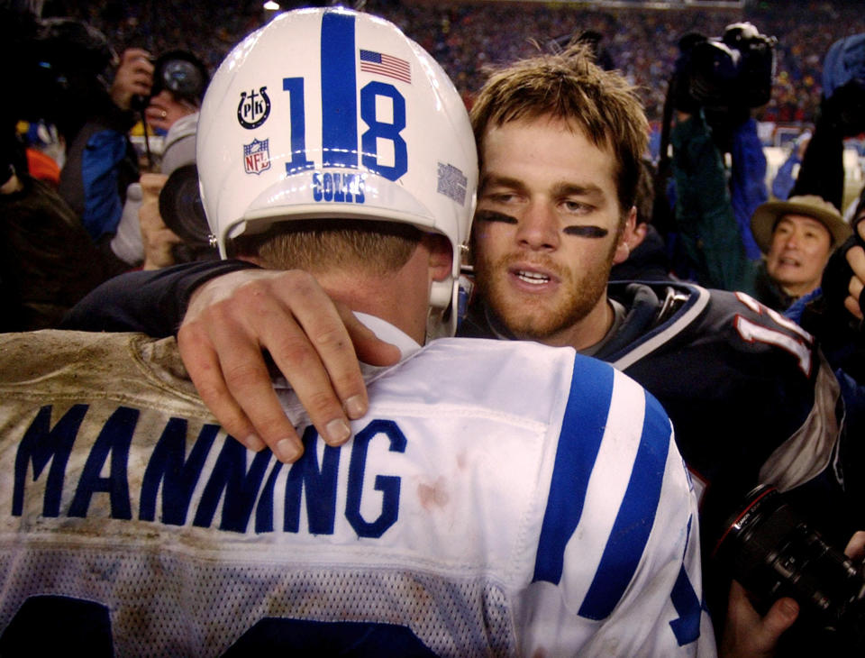 FILE - In this Jan. 18, 2004, file photo, New England Patriots quarterback Tom Brady, right, talks with Indianapolis Colts quarterback Peyton Manning after the Patriots 24-14 win during their AFC Championship game in Foxborough, Mass. Brady, the seven-time Super Bowl winner with New England and Tampa Bay, announced his retirement from the NFL on Wednesday, Feb. 1, 2023 exactly one year after first saying his playing days were over. He leaves the NFL with more wins, yards passing and touchdowns than any other quarterback. (AP Photo/Charles Krupa, File)